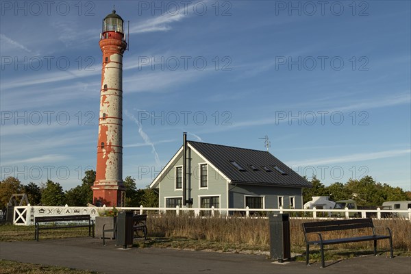 Weathered lighthouse in the evening light against a blue sky on Pakri Peninsula