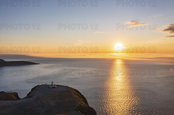 Steel globe at the North Cape under the midnight sun