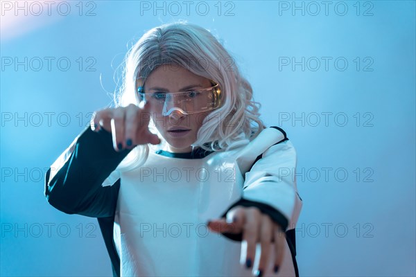 Woman looking through the illuminated futuristic glasses