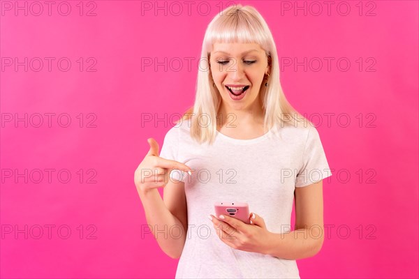 Blonde caucasian girl on pink studio background