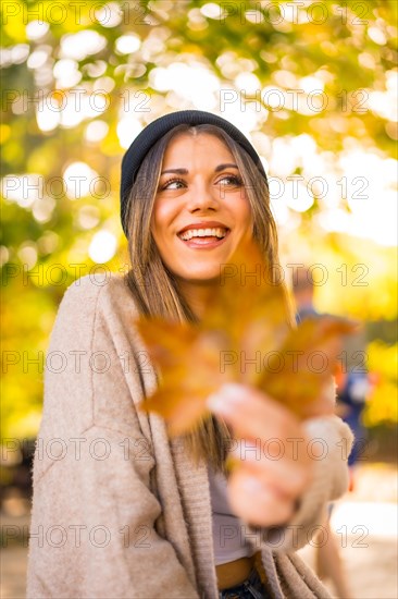 Young blonde girl with a wool cap in autumn