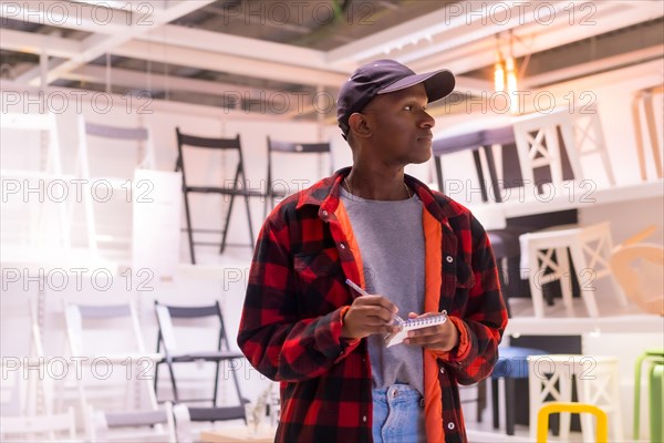 Black ethnic man shopping in a furniture store