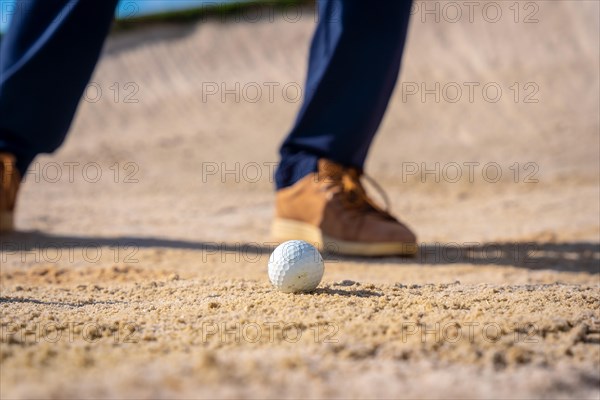 Detail of the feet of a man playing golf