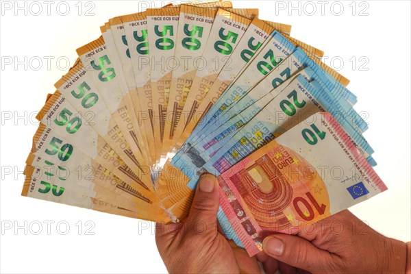 Woman's hands holding fan-shaped euro banknotes with white background and copy space