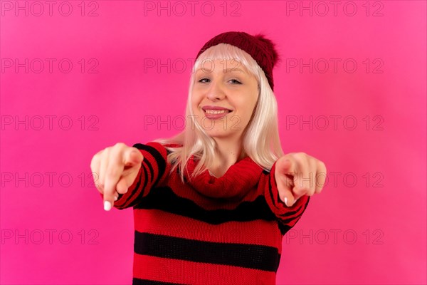 Blonde caucasian girl on pink background studio