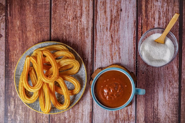 Hot chocolate with churros in a white and blue cup