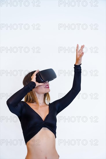 Woman wearing virtual reality goggles on white background