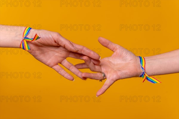 Detail of two hands of two women caressing and touching each other's fingers