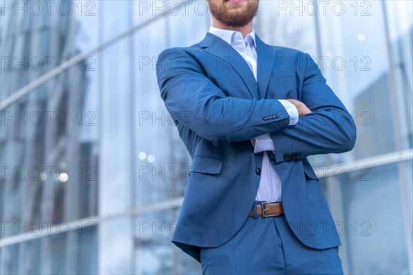 Unrecognizable person corporate businessman outside the office in a glass building
