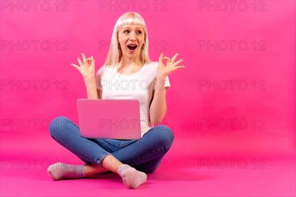 Blonde caucasian girl with a computer