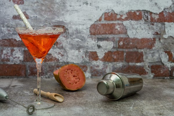 Refreshing squeezed guava cocktail with ice and cocktail shaker