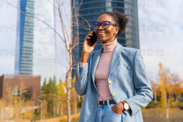 Portrait of black ethnic businesswoman wearing glasses in a business park