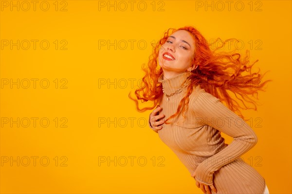 Red-haired woman on a yellow background