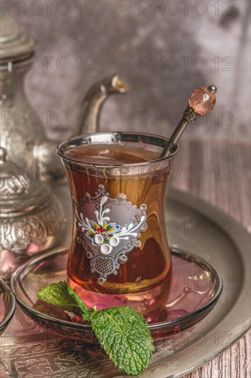 Tray with glasses and serving pitcher of authentic Moorish tea ready to drink with mint leaves