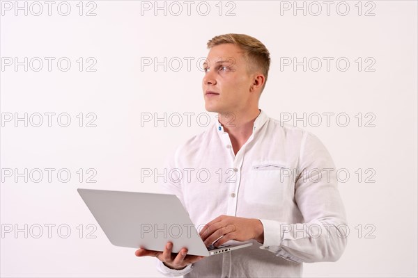 Caucasian businessman man with a laptop computer working on a white background