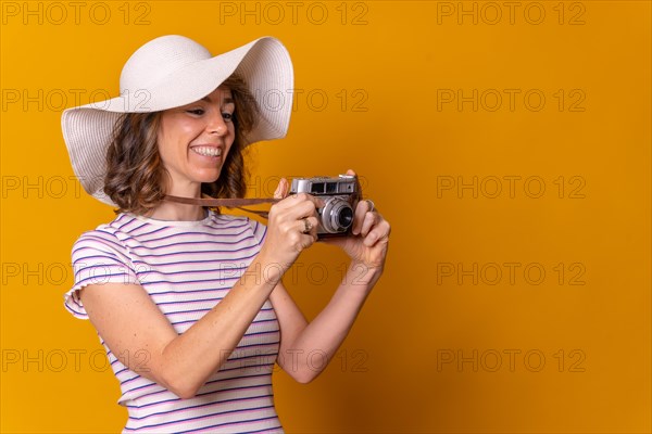 Caucasian girl in tourist concept with hat and photo camera enjoying vacation