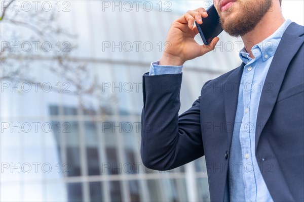 Unrecognizable businessman or finance person on a work call outside the office