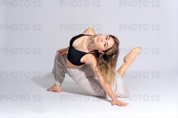 Young dancer in a studio photo session with a white background