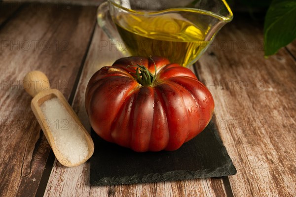 Moorish tomatoes with jar of olive oil and wooden spoon with salt