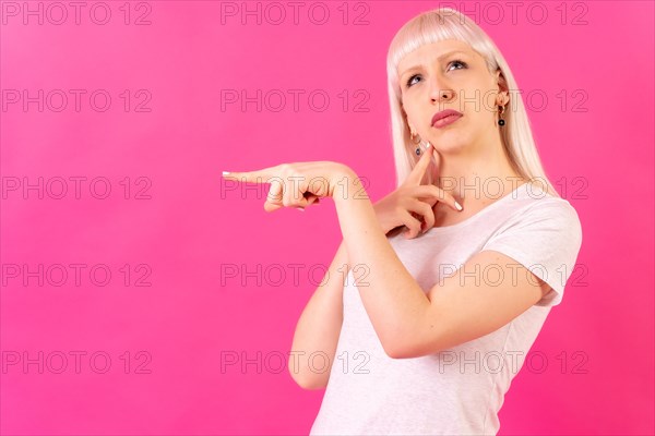 Blonde caucasian girl studio shot on pink background