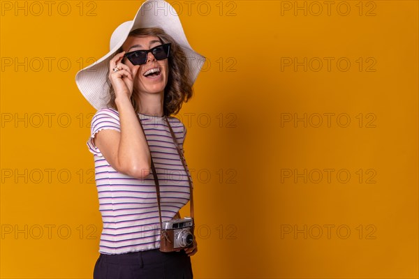 Caucasian girl in tourist concept smiling with a hat and sunglasses enjoying summer vacation