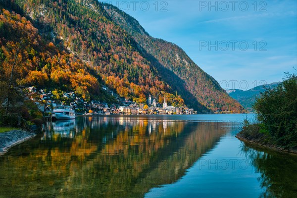 Austrian tourist destination Hallstatt village on Hallstatter See lake lake in Austrian alps with tourist boat. Salzkammergut region