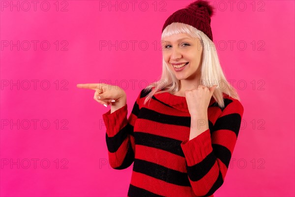 Blonde caucasian girl on pink background studio