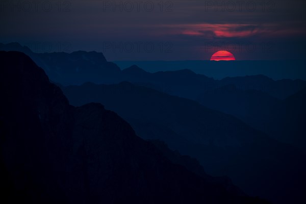 Fiery sunball at sunset with Lechtaler Alps