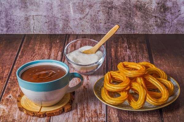 Hot chocolate with churros in a white and blue cup