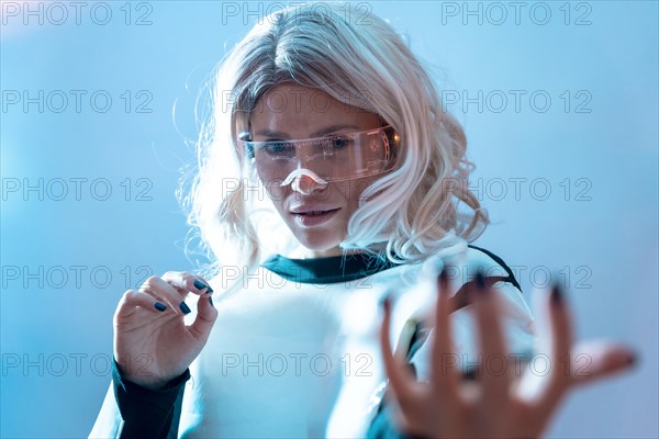 Woman with illuminated futuristic glasses and white hair