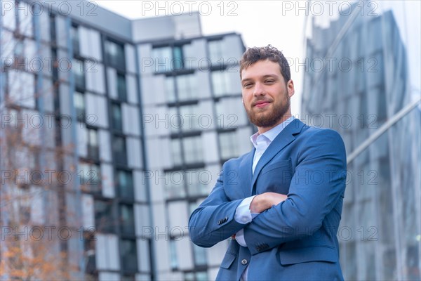 Portrait of professional corporate man businessman outside the office in a glass building
