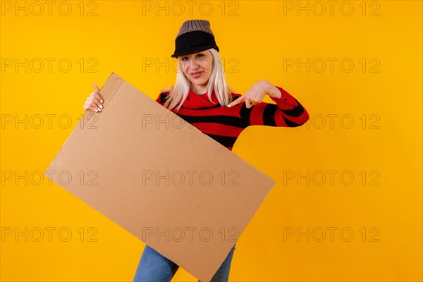 Pointing to empty cardboard advertisement poster