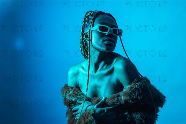 Attractive black ethnic woman with braids with blue led lights