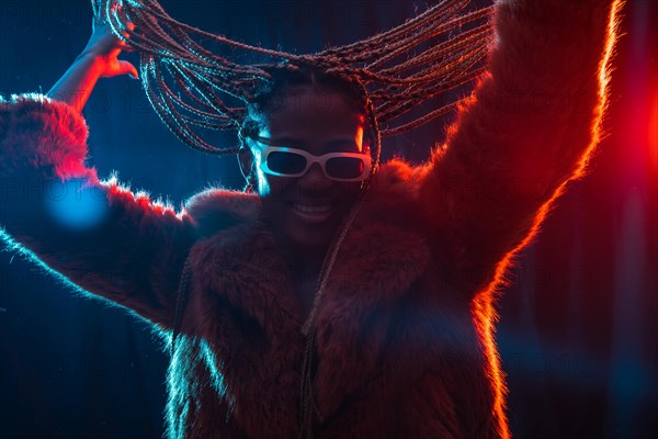 Black ethnic woman with braids with blue and red led lights