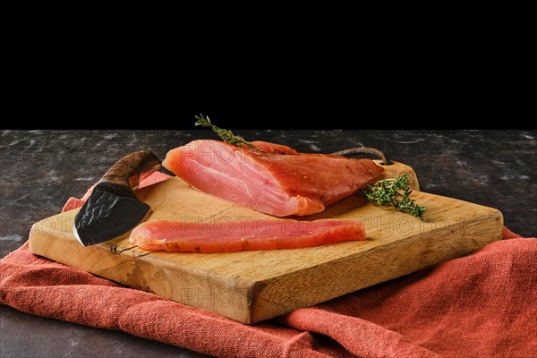 Air dried turkey breast on wooden cutting board