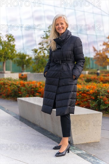 Corporate portrait of white-haired middle-aged businesswoman