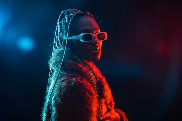 Black ethnic woman with braids with blue and red led lights