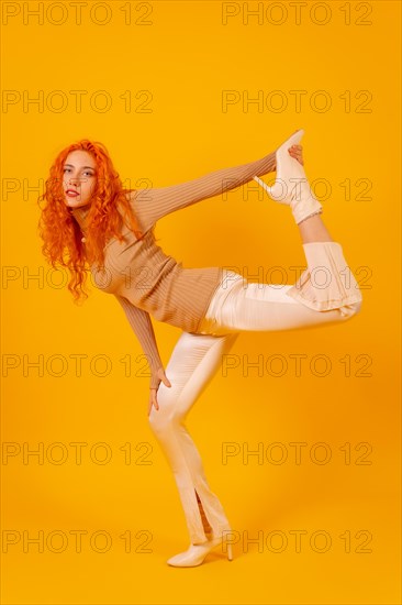 Red-haired woman on a yellow background