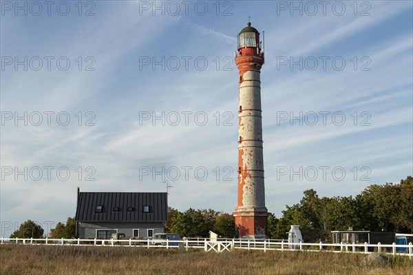 Weathered lighthouse in the evening light against a blue sky on Pakri Peninsula