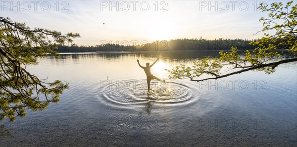 Young man stretching his arms in the air