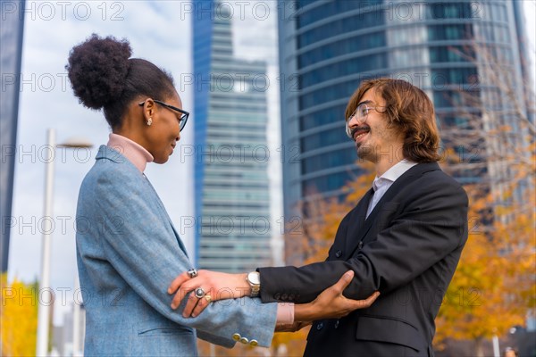 Multiethnic businessmen and businesswomen greeting each other