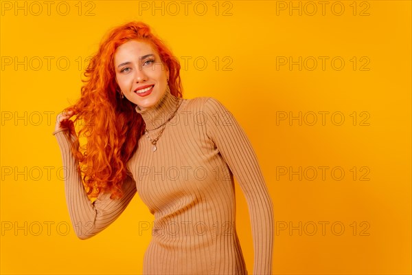 Red-haired woman on a yellow background