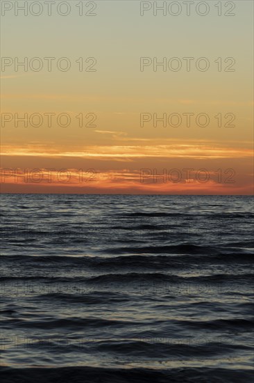 Waves on the Baltic Sea and sunset in summer on the beach of Kloogaranna