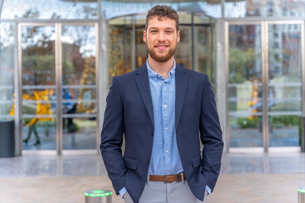 Portrait young businessman CEO of a company at the entrance of the office