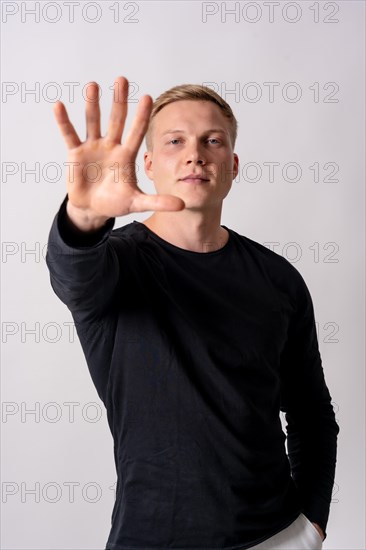 Attractive blonde german model in a black jersey on a white background