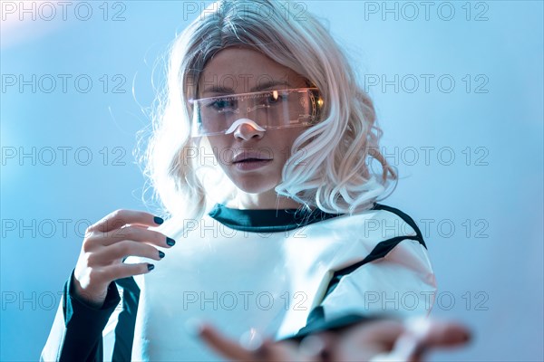 Woman with illuminated futuristic goggles