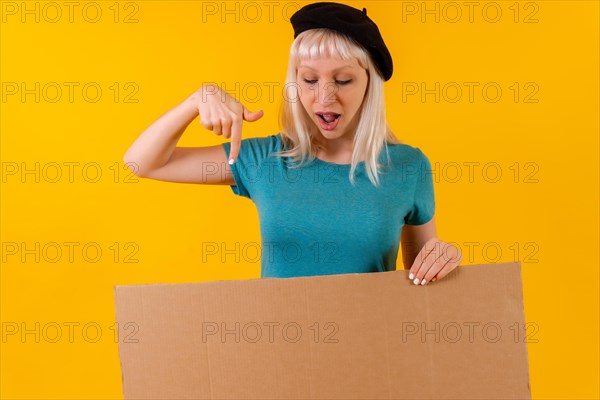 Pointing down a cardboard advertisement poster