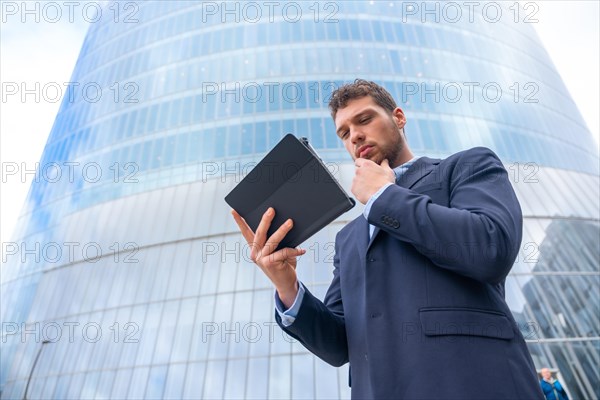 Portrait of a young male businessman or entrepreneur outside the office