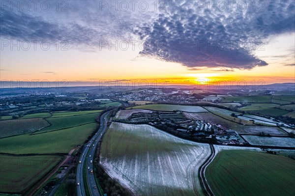 Sunset over Fields and Farms shrouded in frost from a drone