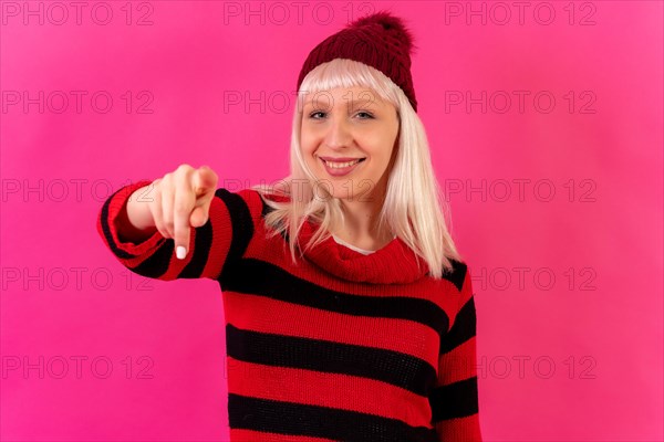 Blonde caucasian girl on pink background studio